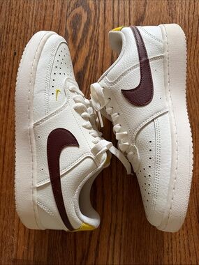 Nike Low-Top Sneakers in White with Brown Swoosh and Yellow Accents